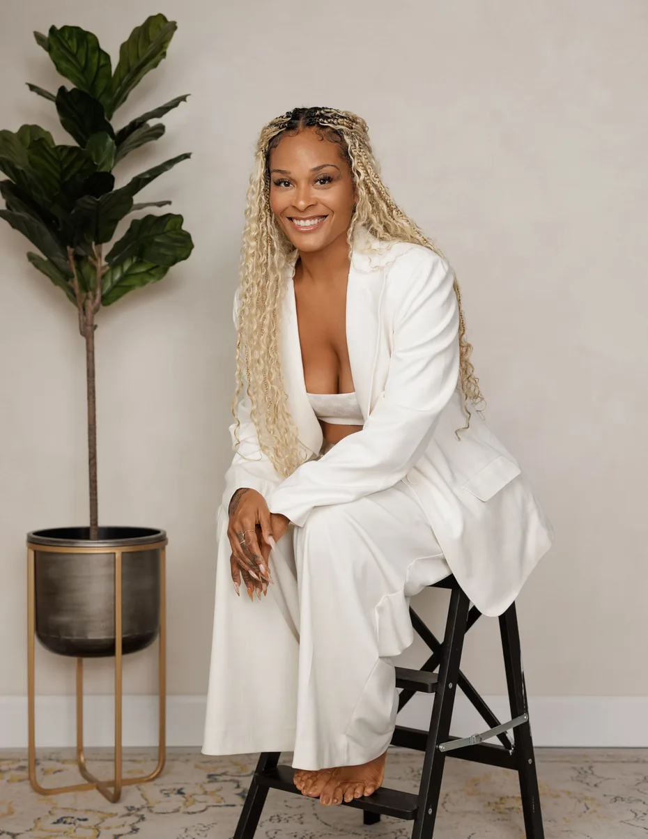 Erin Patten in white, seated on a stool