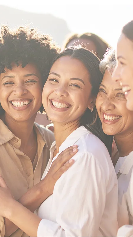 Women smiling together in the sunshine